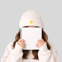 Stockka white acrylic knit beanie with yellow flower embroidery. Unisex winter hat.
