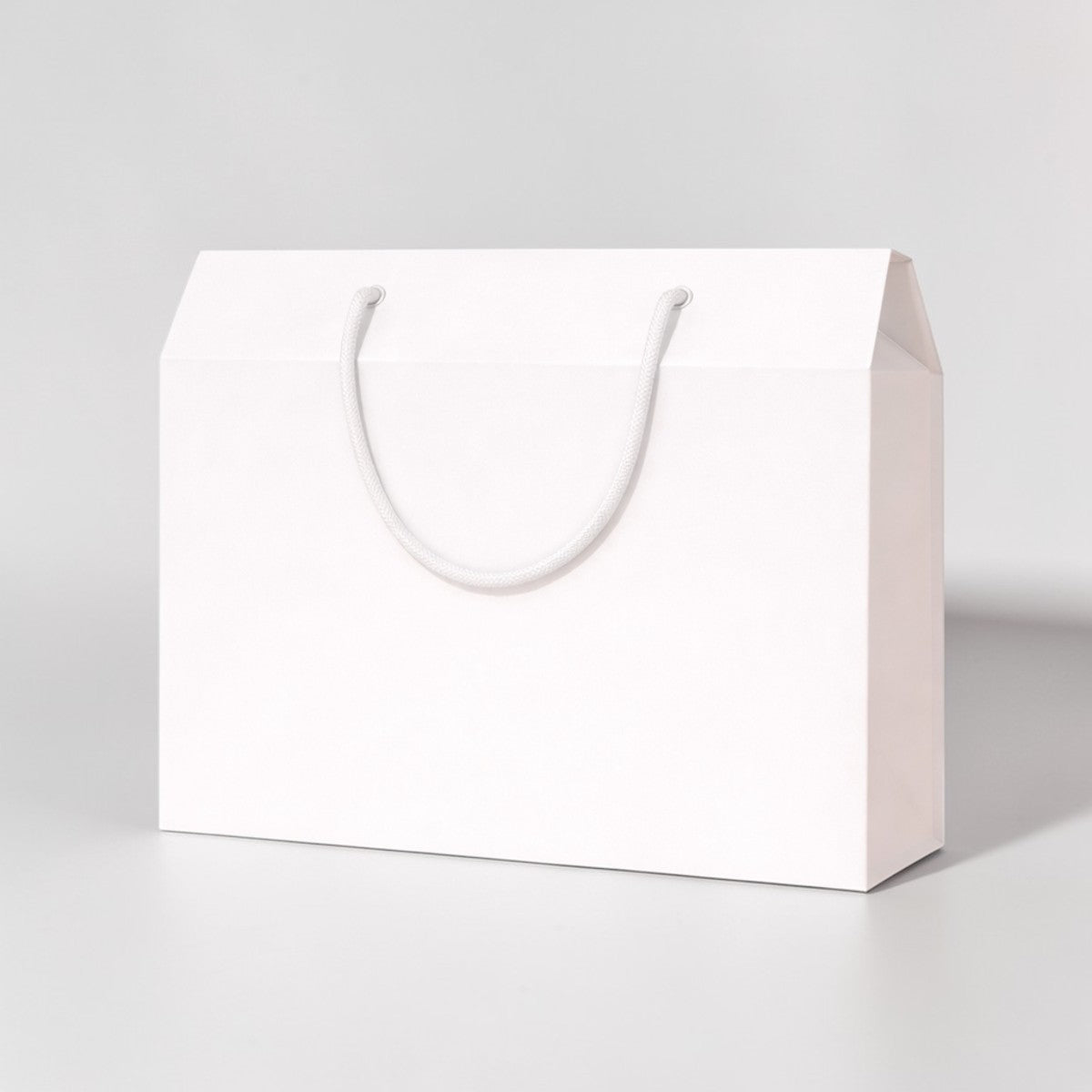 Stockka white kraft paper gift box with rope handle, ideal for luxury gifts and promotions.