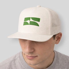 Stockka white cotton mesh trucker hat with flat brim and green logo detail. Adjustable snapback closure.