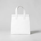 Stockka medium white non-woven polypropylene tote bag with strong handles, ideal for retail and food service.