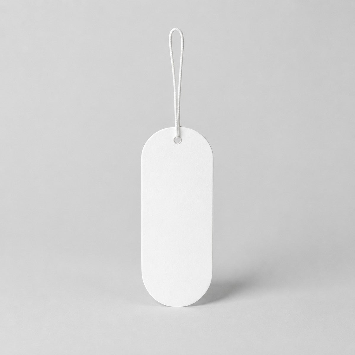 Stockka white oval hang tag with string loop, ideal for clothing and retail products.