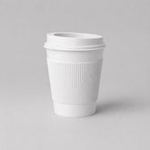 Stockka white paper coffee cup with ribbed kraft sleeve and black plastic lid, 350ml capacity.