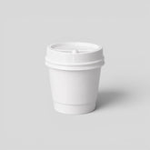 Stockka small white paper espresso cup with a black plastic lid, ideal for events.