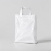 Stockka white plastic shopping bag with soft loop handles, 30x40cm, made from HDPE.