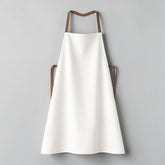 Stockka white full-length wide-cut apron made of polyester-cotton blend with brown straps. Ideal for kitchens, restaurants, and workshops.