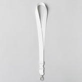 Stockka white polyester flat ID lanyard with plastic breakaway buckle and metal clip. Features subtle blue stripes.