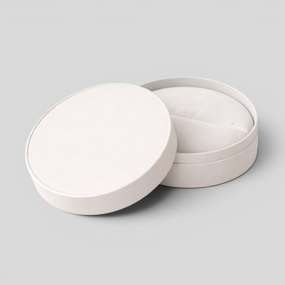 Stockka white round jewelry box with removable lid, made of matte finish rigid cardboard, ideal for rings, earrings, or accessories.