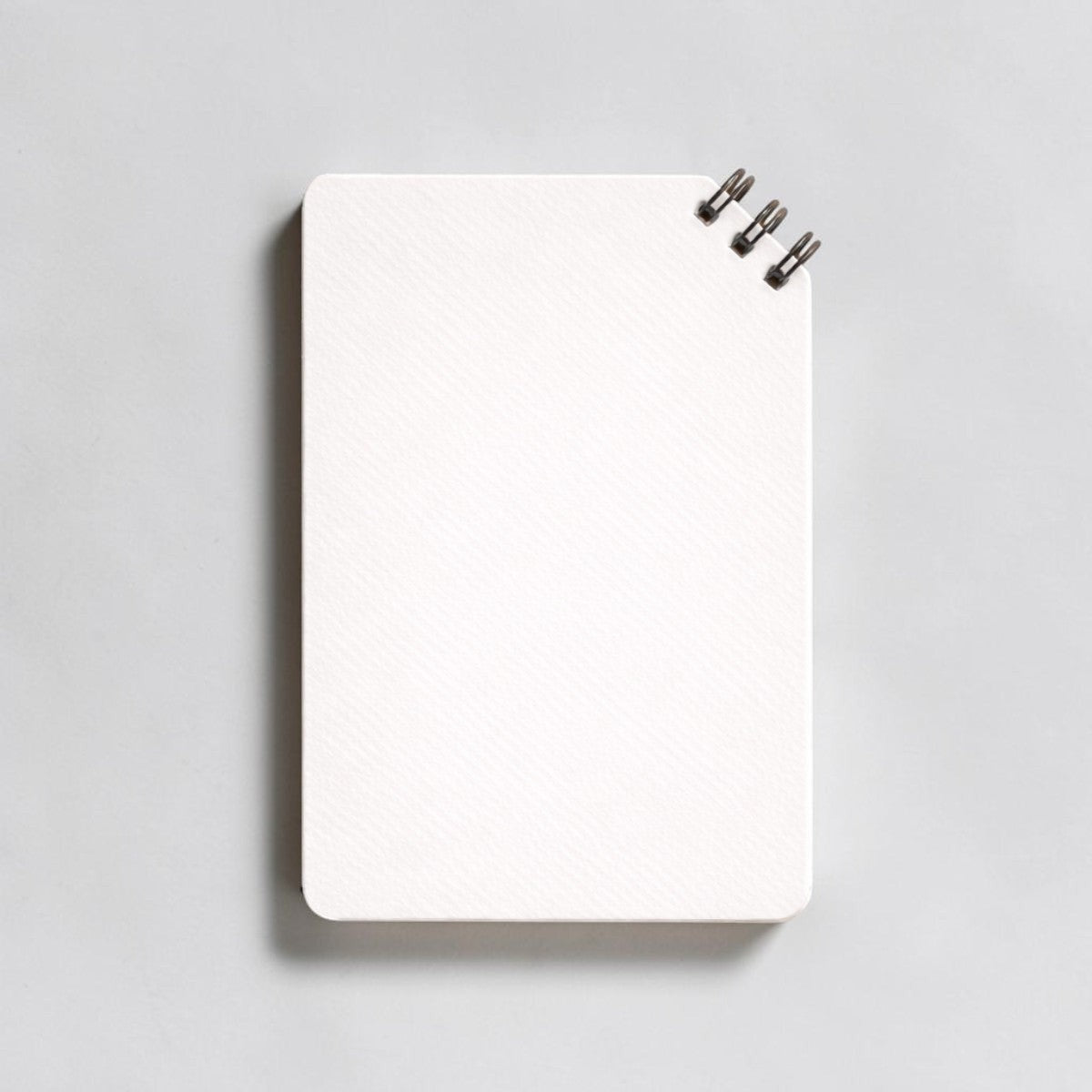 Stockka white spiral notebook with 80 lined pages and soft cover, ideal for custom designs.