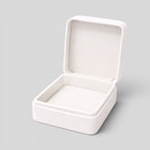 Stockka white square jewelry box with hinged lid and soft interior lining, perfect for rings or necklaces.