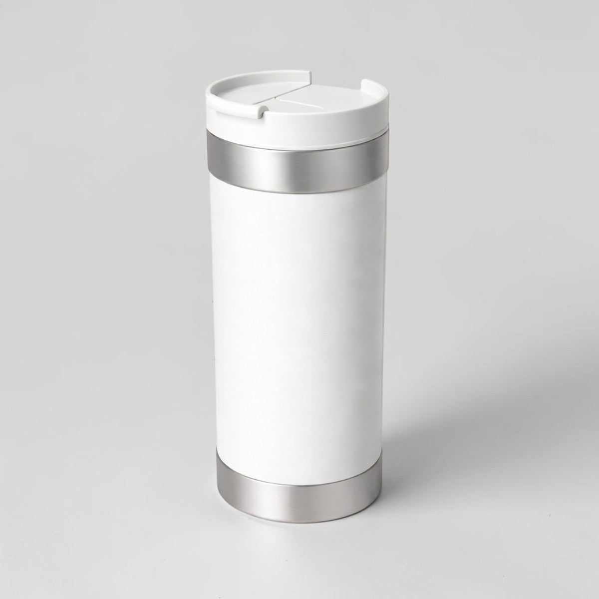 Stockka white stainless steel travel mug with rotating lid and silver accents, 16 oz capacity, double-walled for insulation.