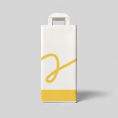 Stockka white paper gift bag with yellow accent and cursive design, ideal for wine or alcohol bottles.