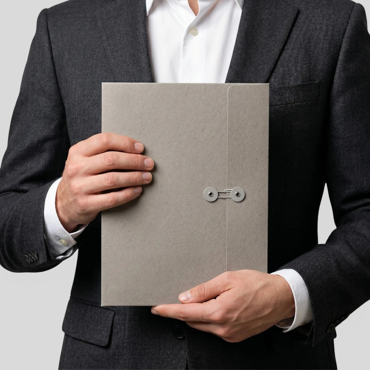 Stockka A4 grey cardboard marketing folder with string closure and circular holders, held by a man in a suit.