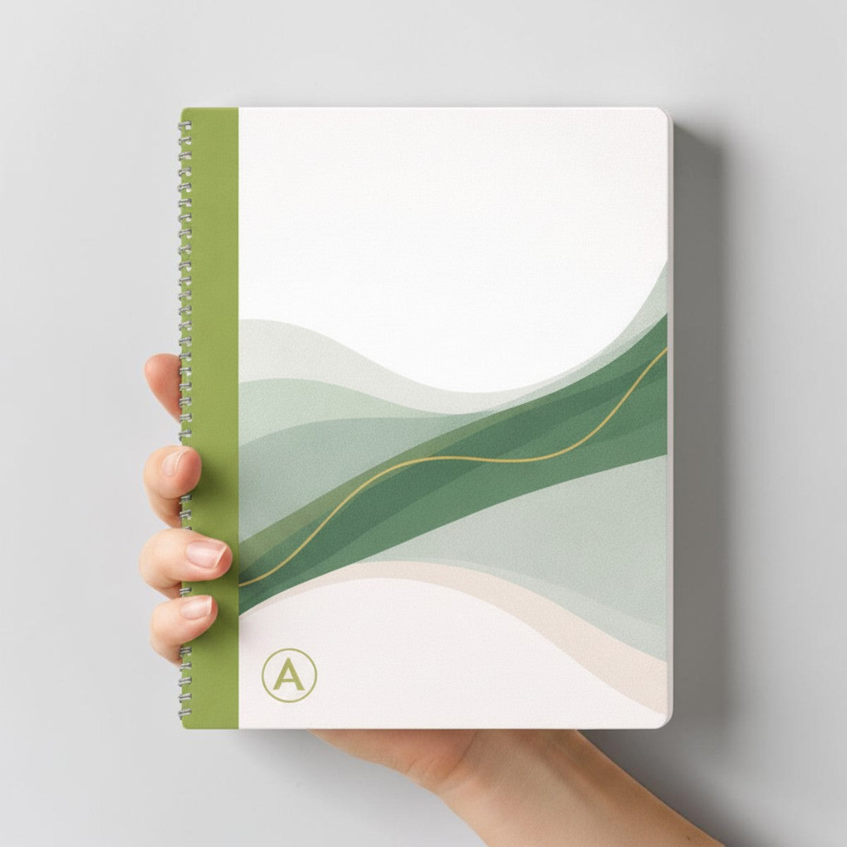 Stockka A4 softcover notebook with spiral binding, featuring a green and white abstract wave design with a gold accent line.