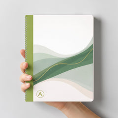 Stockka A4 softcover notebook with spiral binding, featuring a green and white abstract wave design with a gold accent line.