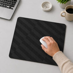 Stockka black rectangular mouse pad with a subtle geometric pattern, used by a hand with a white mouse.