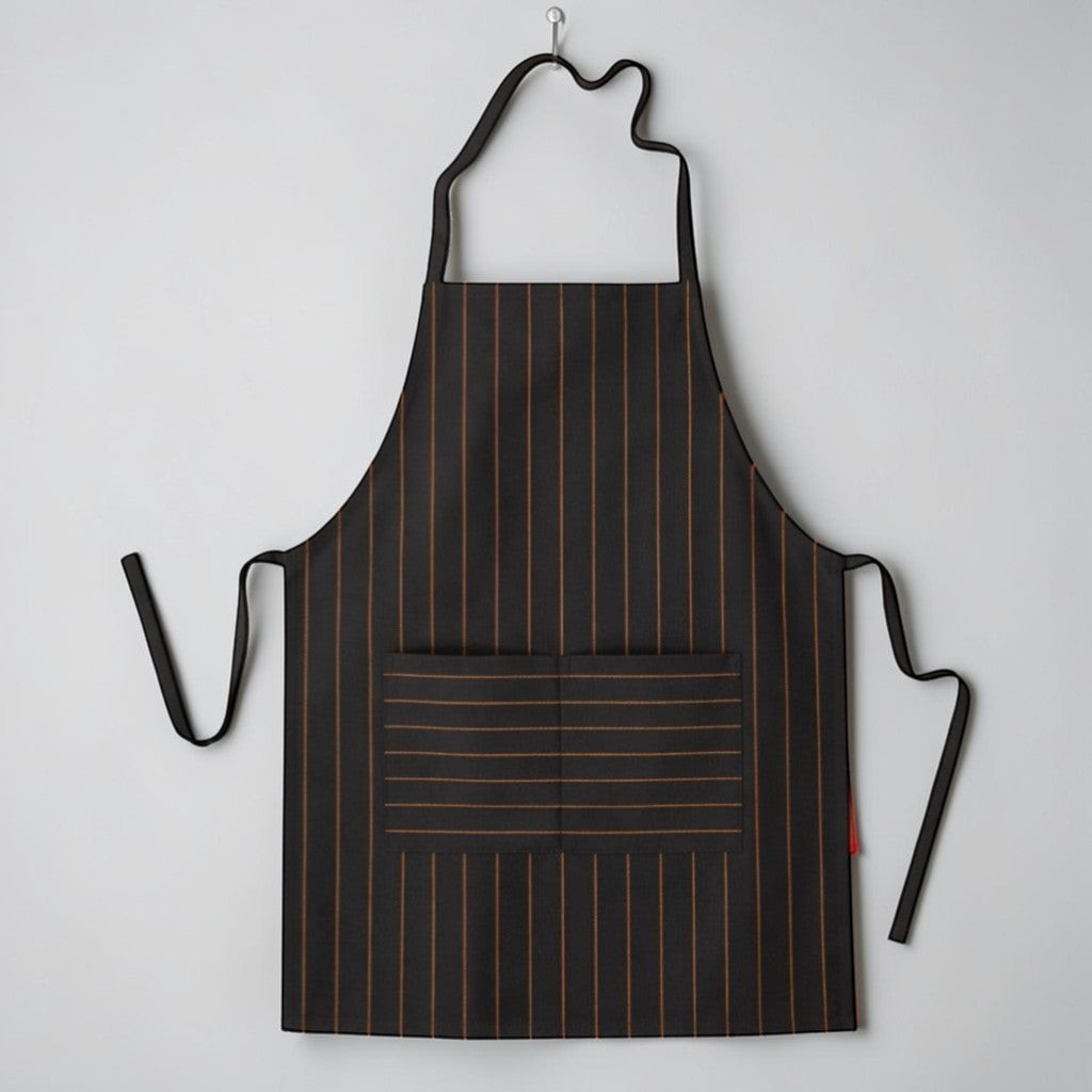 Stockka black and gold pinstripe full-length apron with adjustable neck strap and front pocket. Polyester-cotton blend.
