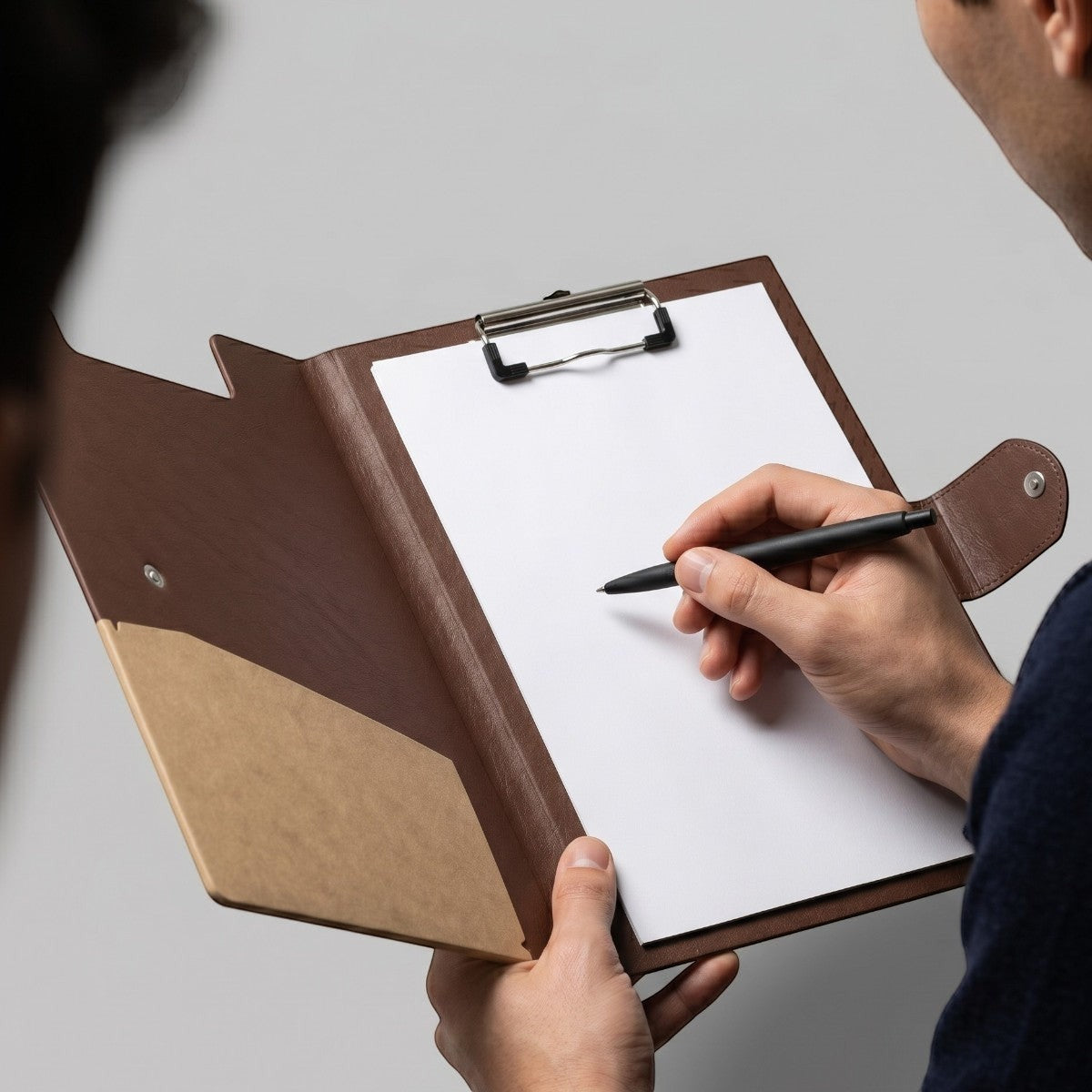 Stockka brown faux leather presentation folder with internal clipboard and document pocket. Ideal for meetings and notes.