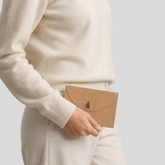 Stockka brown kraft paper envelope with round closure and metal clip, perfect for invitations or luxury stationery.