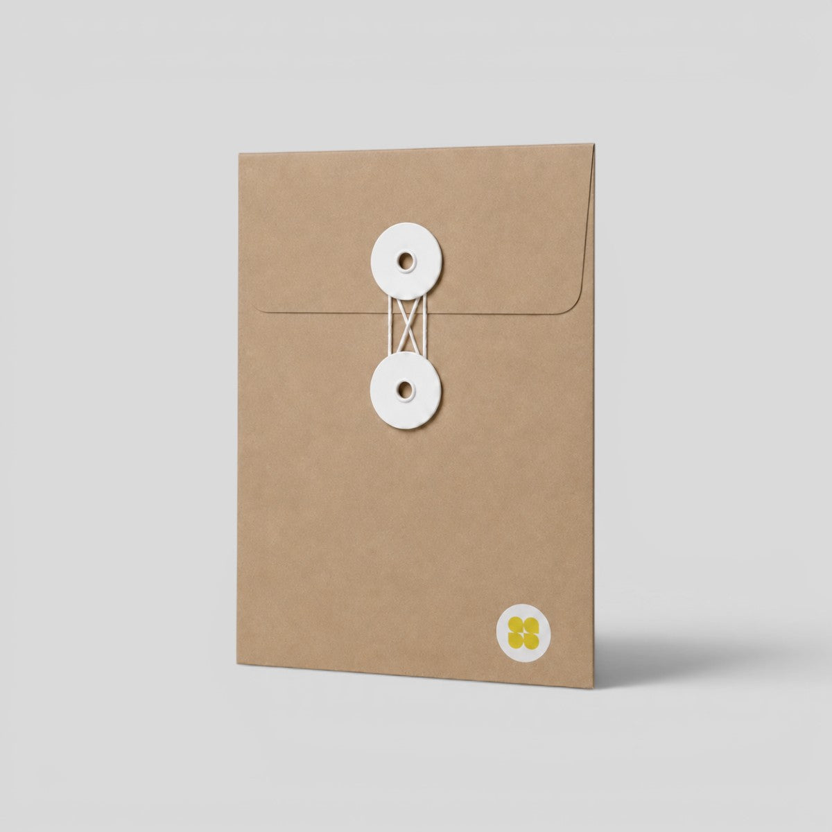 Stockka brown kraft paper envelope with white string and disc closure for elegant document storage