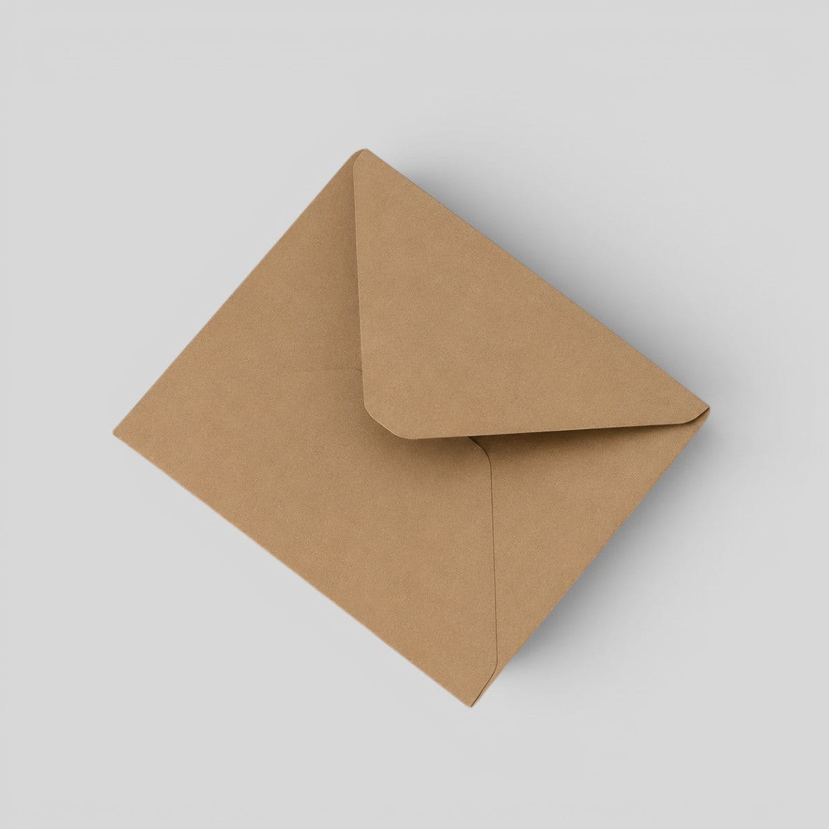 Stockka brown kraft paper envelope with classic triangular flap closure, perfect for invitations and cards.