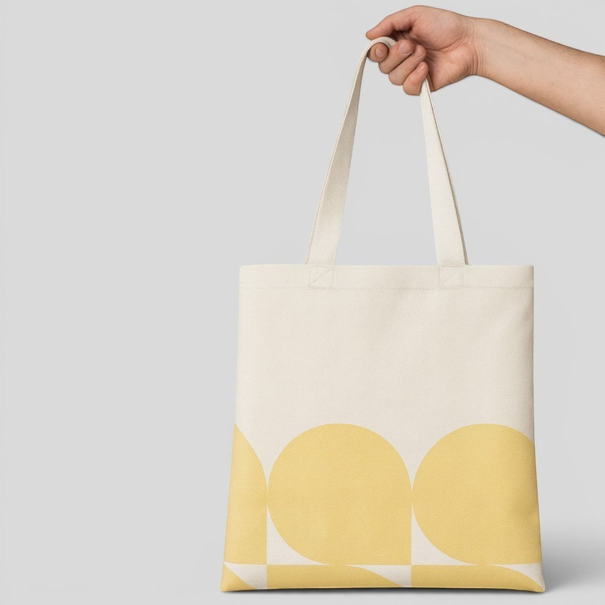 Stockka natural cotton canvas tote bag with a yellow geometric circle pattern. Reusable and ideal for custom printing.