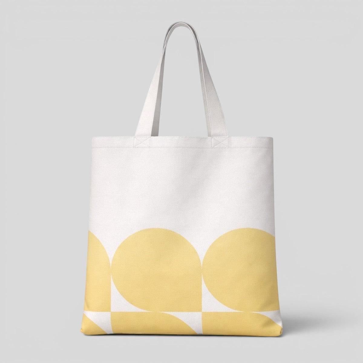 Stockka white canvas tote bag with a yellow abstract geometric pattern. Made of 100% natural cotton.