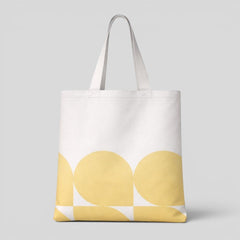 Stockka white canvas tote bag with a yellow abstract geometric pattern. Made of 100% natural cotton.