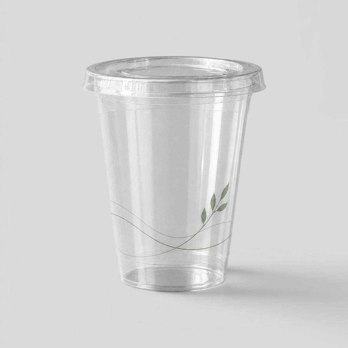 Stockka clear PET plastic cup with flat lid and subtle green leaf design, ideal for cold drinks and takeaway.