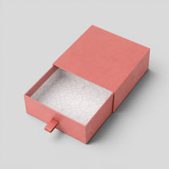 Stockka coral pink rigid cardboard jewelry box with drawer and fabric pull tab, patterned interior.