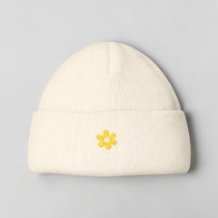 Stockka cream acrylic beanie with yellow embroidered flower detail. Double knit for warmth.