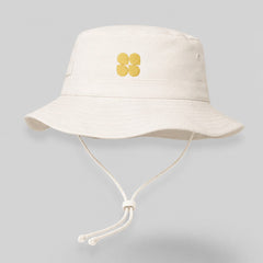 Stockka cream cotton blend bucket hat with yellow embroidered abstract pattern and adjustable chin strap.