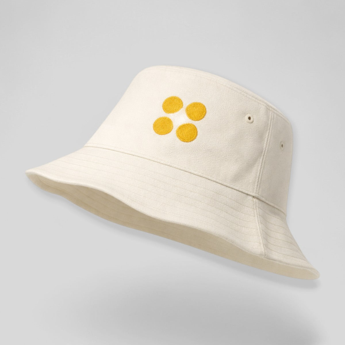 Stockka cream cotton bucket hat with yellow embroidered dots. Unisex, adjustable fit, lightweight and durable.