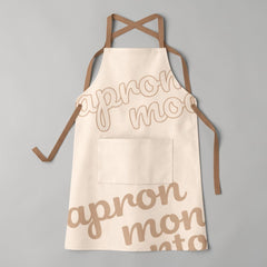 Stockka full-length apron in cream cotton-poly blend with brown cross-back straps and a large front pocket.