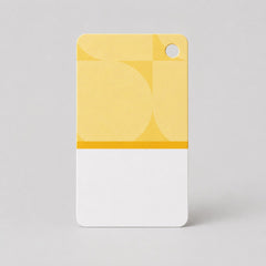 Stockka custom branded clothing tag, yellow and white with geometric pattern and hole for hanging.