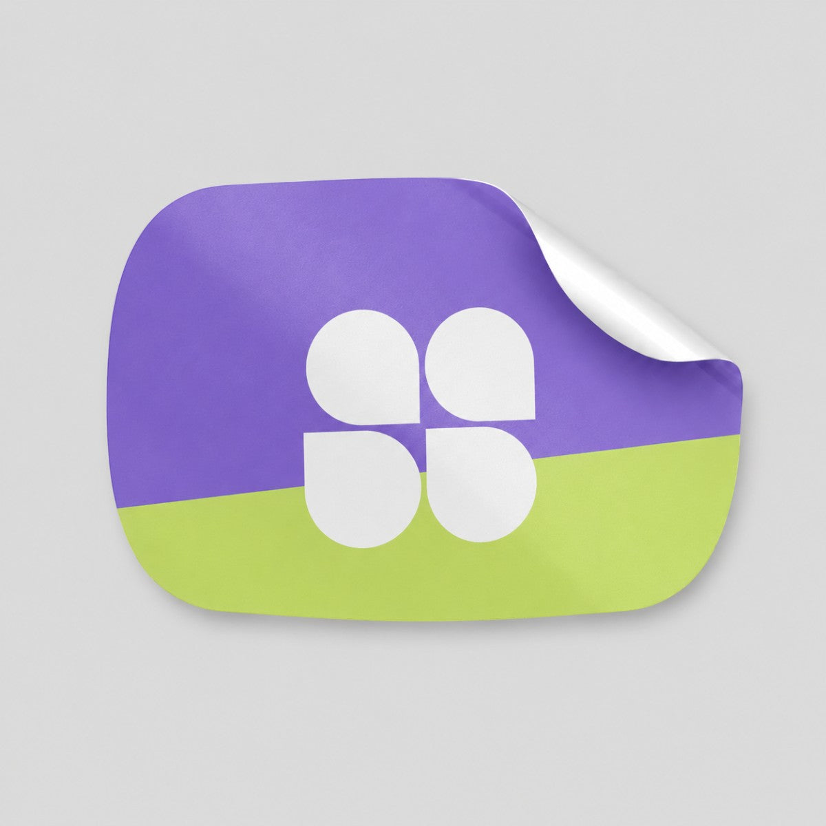 Stockka custom die-cut sticker with rounded corners, featuring a split design of purple and lime green with a white four-petal clover logo.