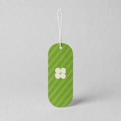Stockka custom branded hang tag with green stripes and a white four-petal logo, made of cardstock.
