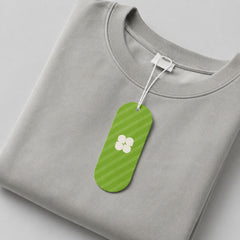 Stockka custom branded hang tag with green stripes and white clover logo, attached to a grey sweatshirt.