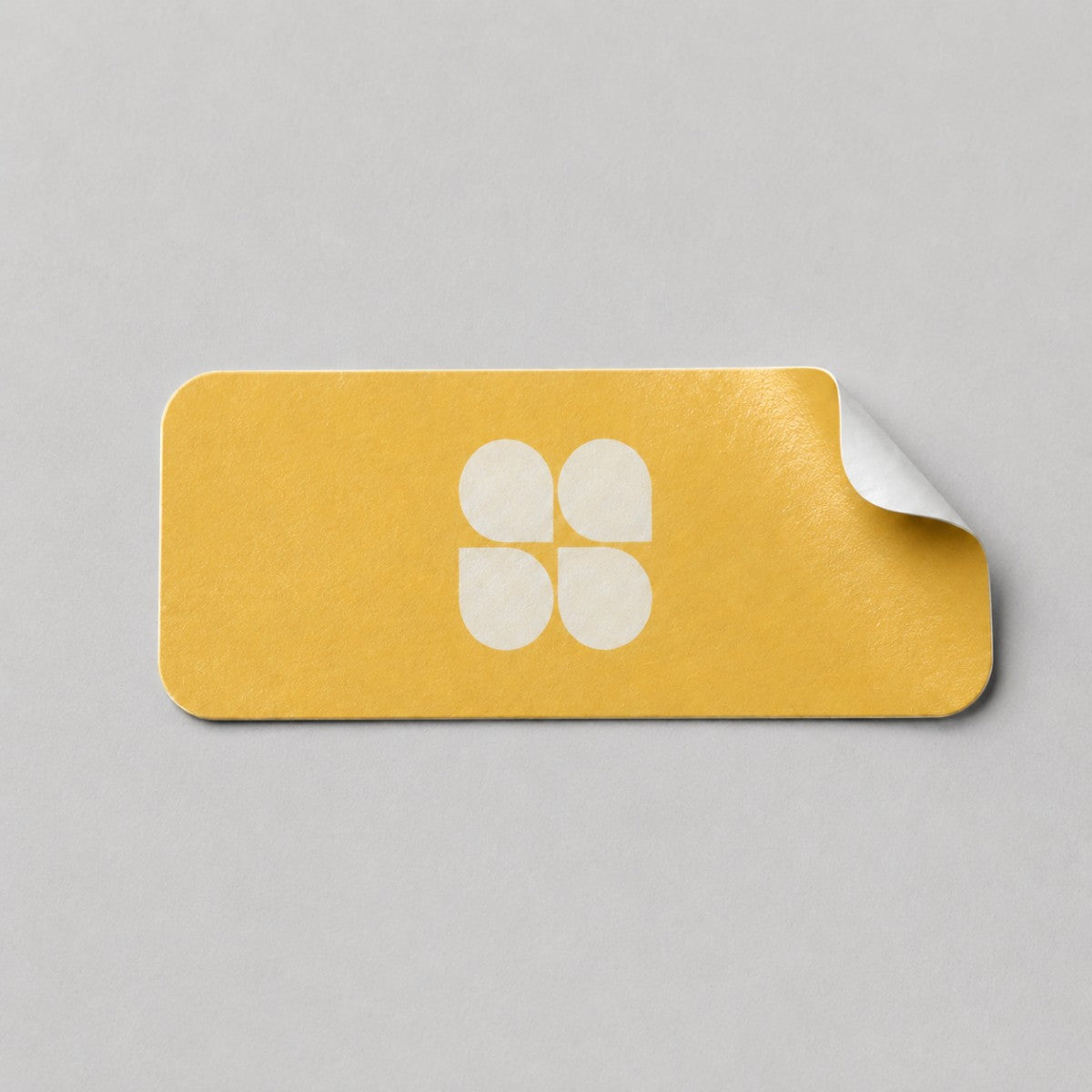 Stockka yellow rectangular sticker with rounded corners and a white four-petal logo. Easy peel.