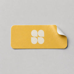 Stockka yellow rectangular sticker with rounded corners and a white four-petal logo. Easy peel.