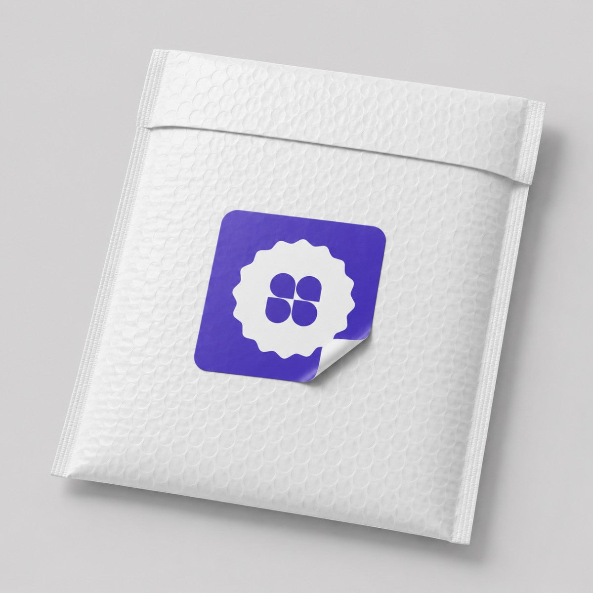 Stockka custom designed seal sticker with a white scalloped edge and a purple background featuring a white four-leaf clover design.