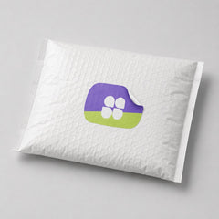 Stockka custom shaped sticker with rounded edges, purple and lime green design with four white shapes. Applied to a white padded envelope.