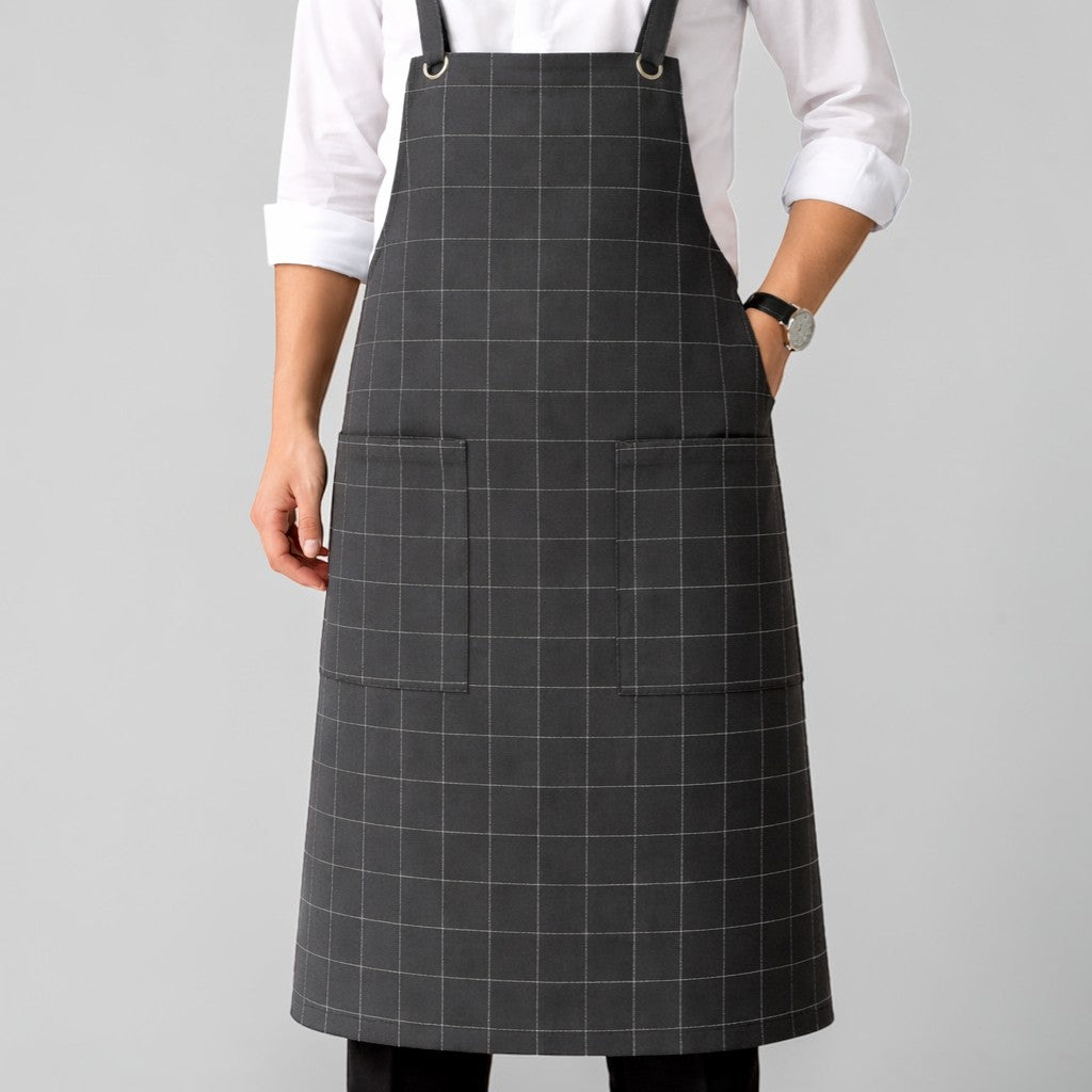 Stockka dark grey checkered cotton-polyester blend work apron with two large front pockets and metal ring shoulder straps.