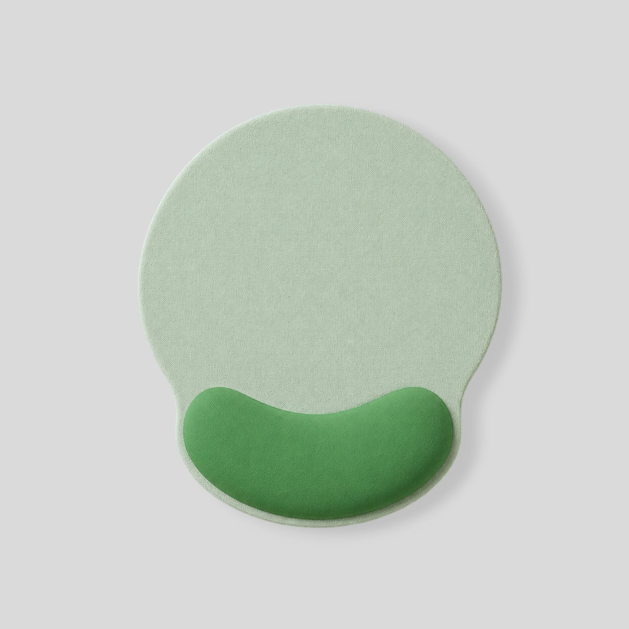Stockka ergonomic round mouse pad in light green with a darker green wrist rest for comfortable use.