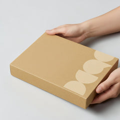Stockka flat cardboard box with a decorative pattern of light beige semi-circles on the lid, ideal for games, catalogs, or branding.