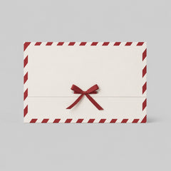 Stockka festive cream paper gift envelope with red diagonal border and red satin ribbon bow closure.