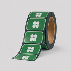 Stockka green rectangular stickers with rounded corners, featuring a white four-petal flower design. Supplied on a roll.