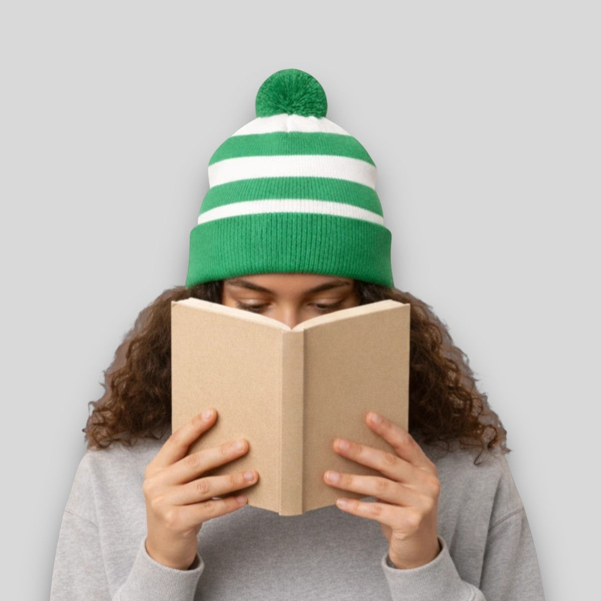 Stockka green and white striped acrylic knit beanie with pom-pom. Unisex winter hat.