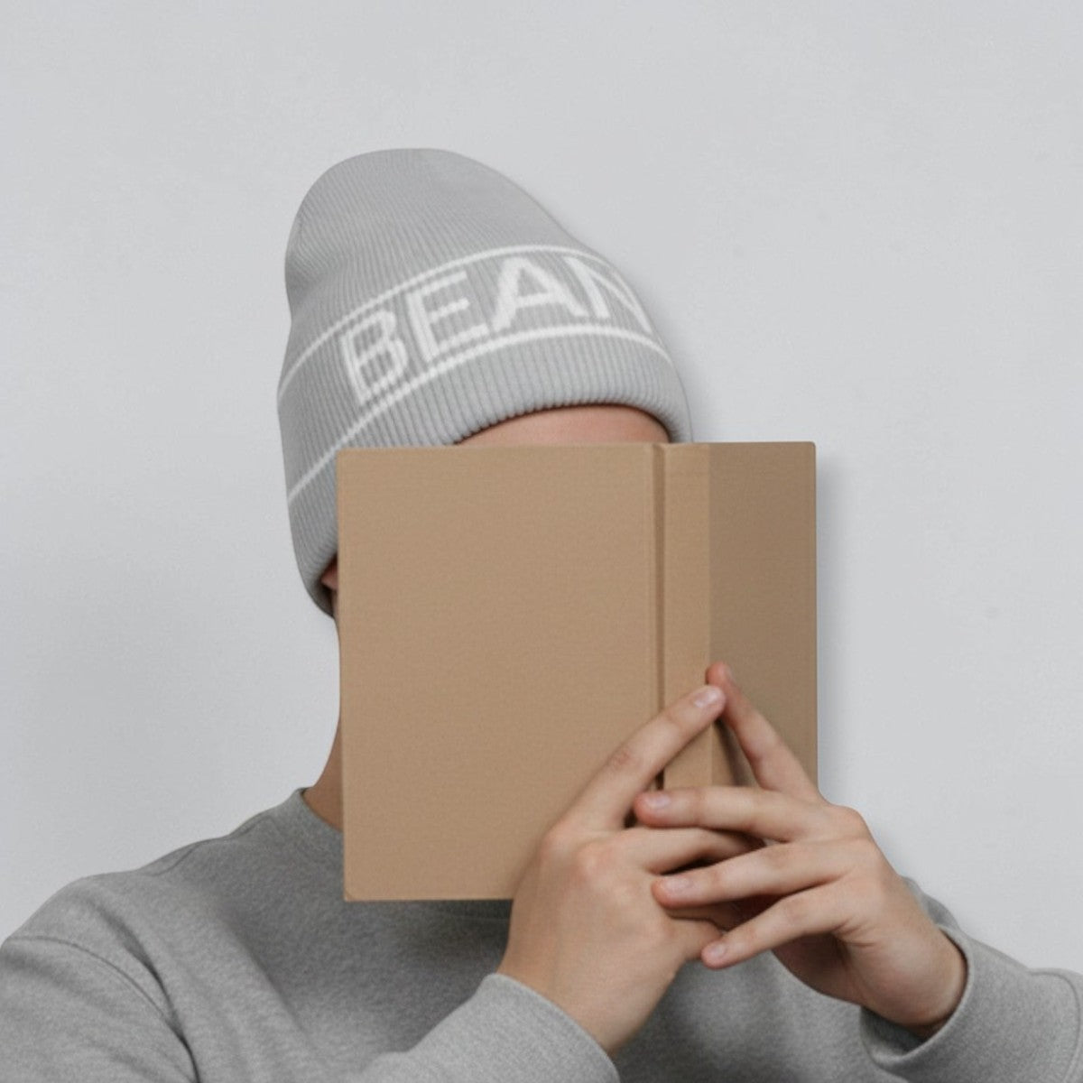 Stockka grey acrylic double knit unisex beanie with white stripe detail and text.