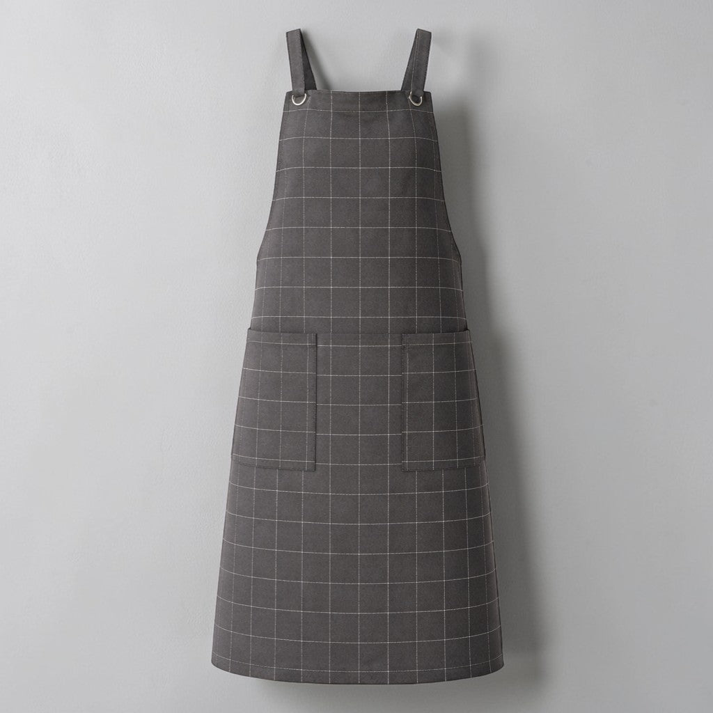 Stockka dark grey checkered cotton-polyester work apron with two large front pockets and metal ring shoulder straps.