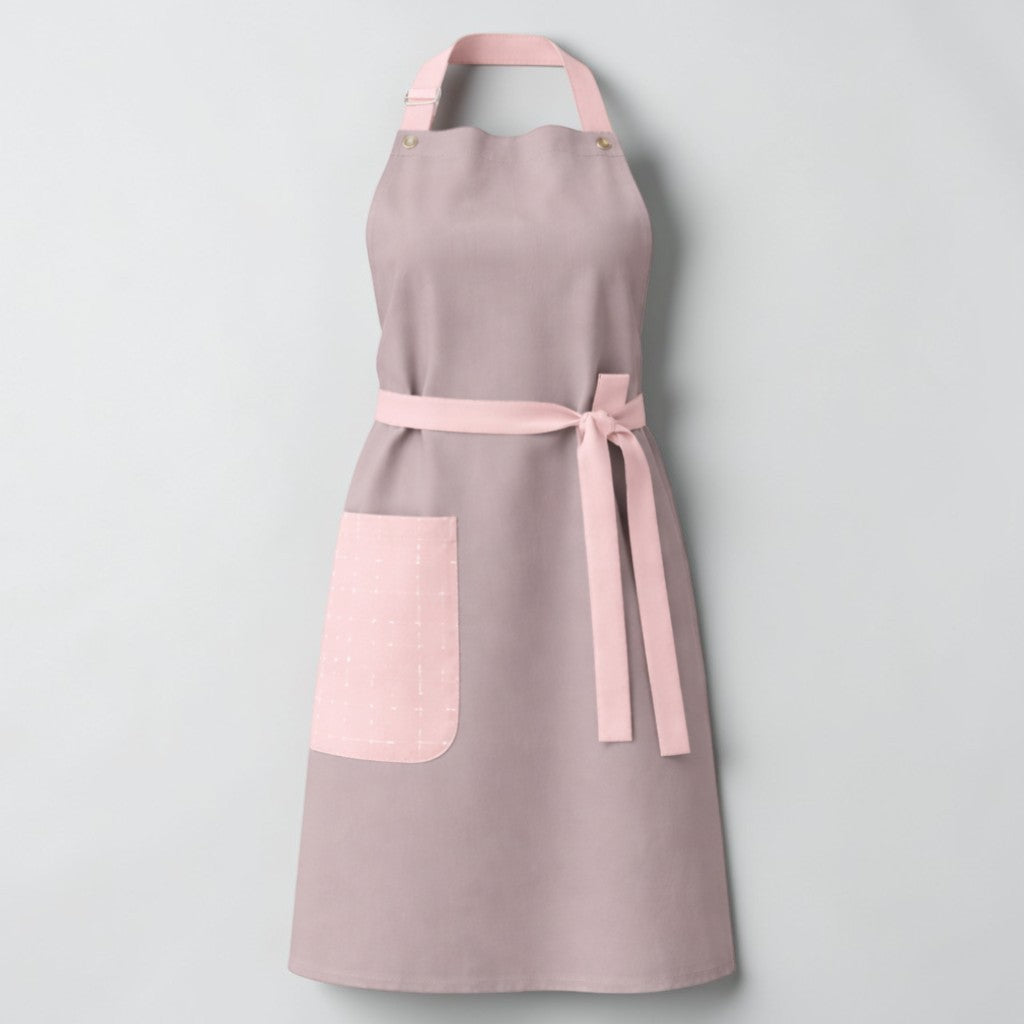 Stockka elegant grey cotton-polyester blend apron with pink trim and side pocket. Adjustable neck strap.